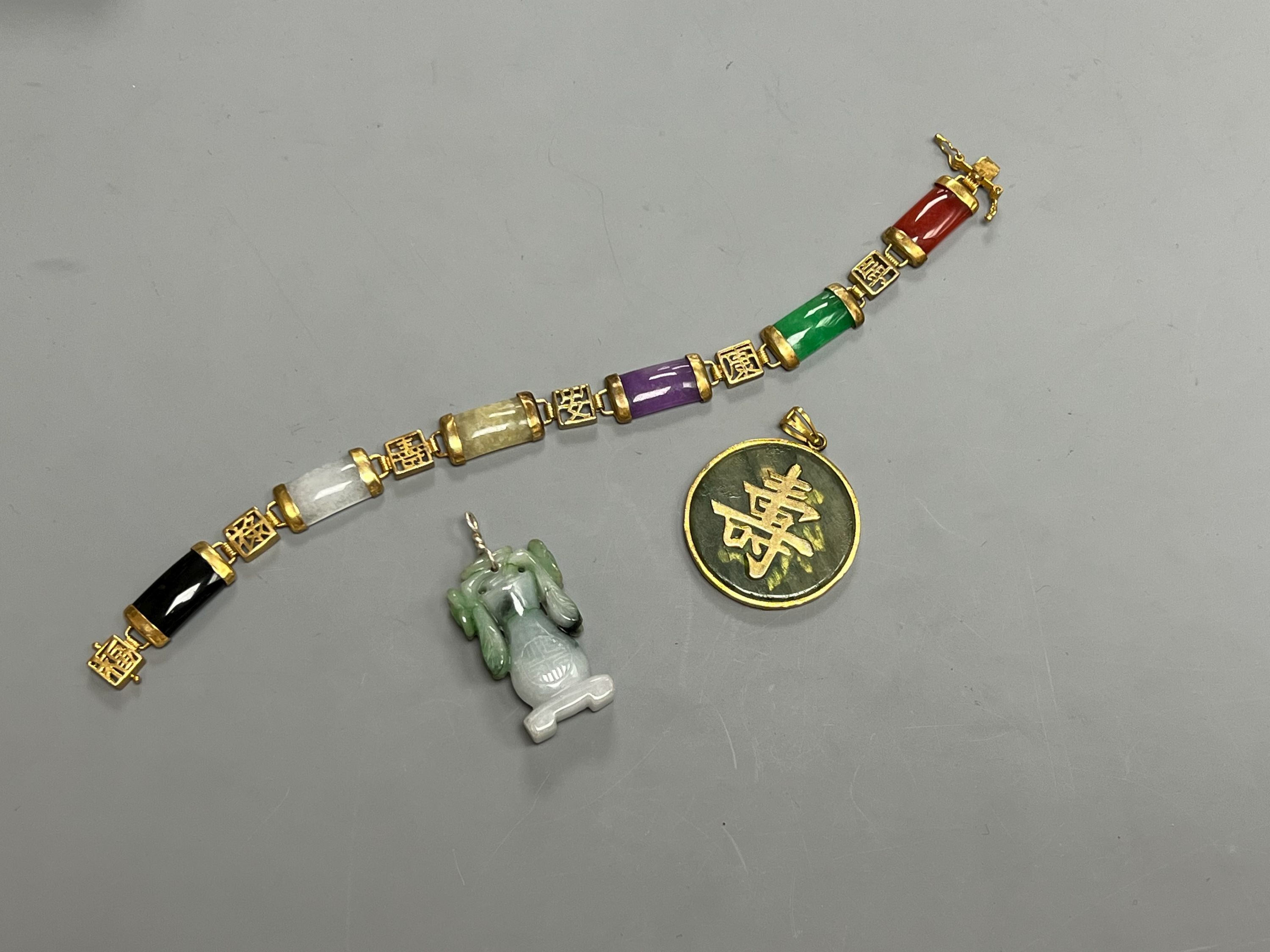 A Chinese multi coloured jadeite bracelet, and two jadeite pendants